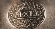 A close view of a stamped silver hallmark.