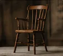 A wooden Windsor armchair.